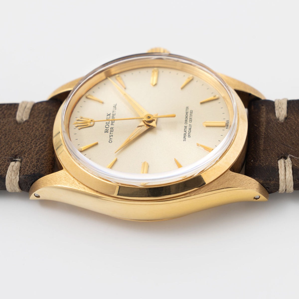 Rolex Oyster Perpetual 1002 Silver Soleil Swiss Only Dial in 18 k yellow gold Coca Cola