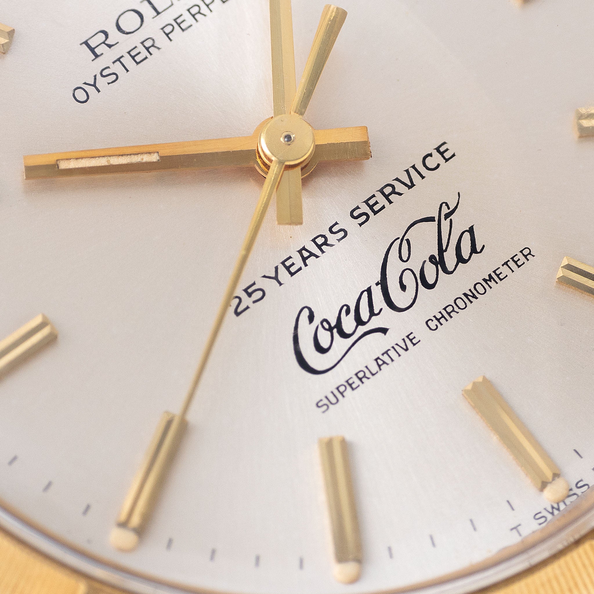 Rolex Oyster -Perpetual silver "25 years Coca Cola service " logo dial in 18 k yellow gold with original double punched papers ref 1003