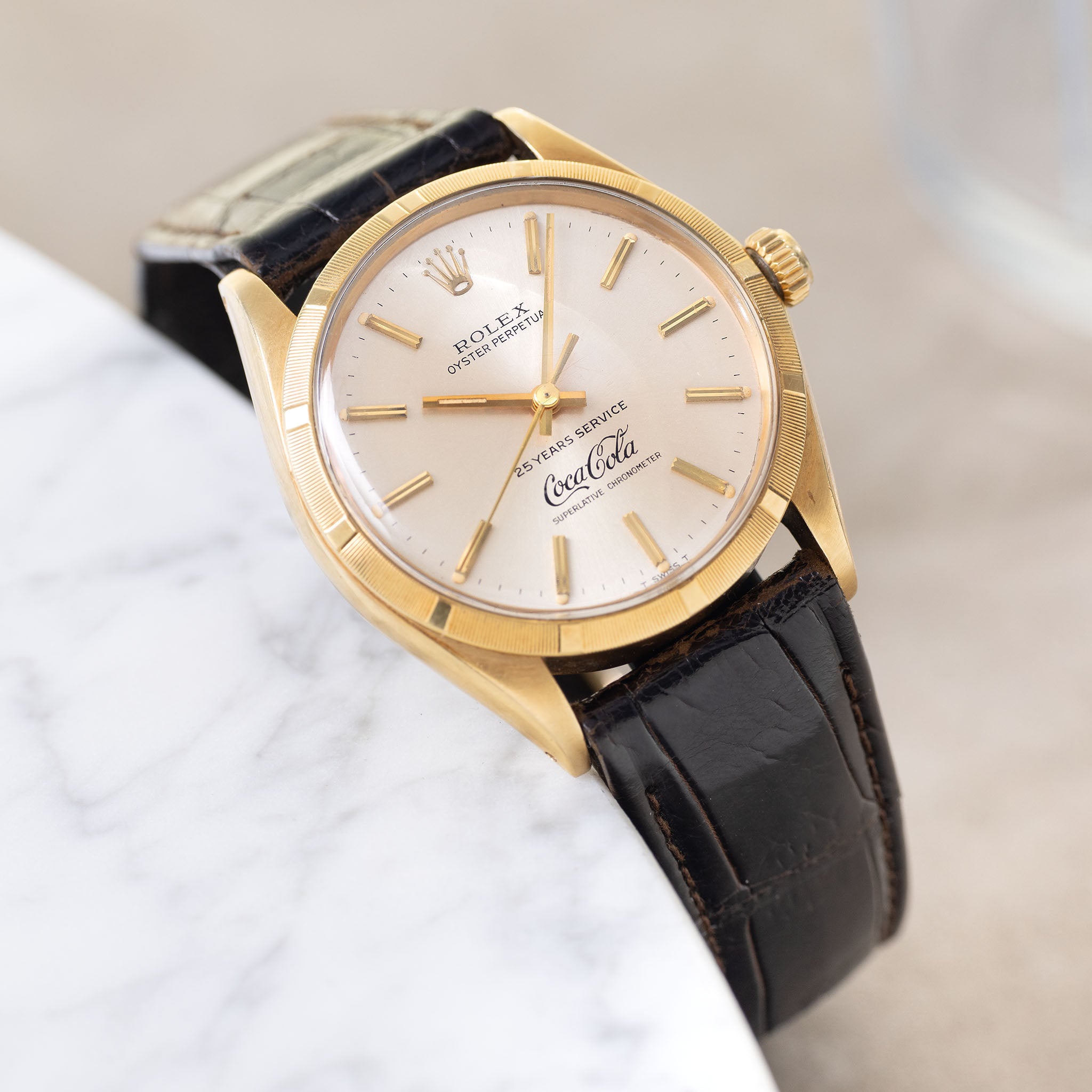 Rolex Oyster -Perpetual silver "25 years Coca Cola service " logo dial in 18 k yellow gold with original double punched papers ref 1003